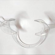 Clear dental cheek retractors used in orthodontic and cosmetic dental procedures